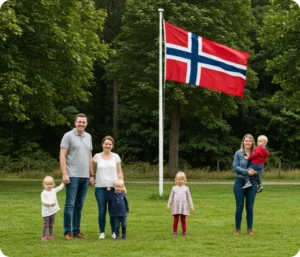 Bildet viser en familie, en kvinne og barn som står med det norske flagget heist bak seg